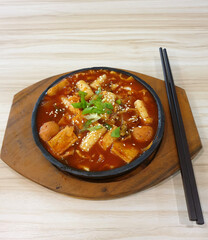 Tteokbokki with a spicy sweet chili sauce. Tteokbokki or stir-fried rice cakes is a Korean traditional food which has sticks of rounded rice cake as the main ingredient