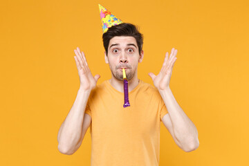 Young unshaved cute happy fun friendly caucasian man 20s in casual t-shirt wearing birthday hat...