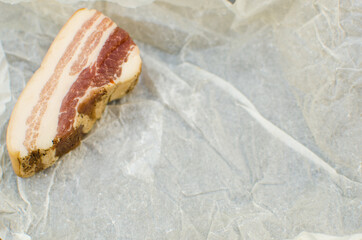 Raw pork lard with meat, on a gray background for copy space. A large chunk of fresh fat. Ukrainian...