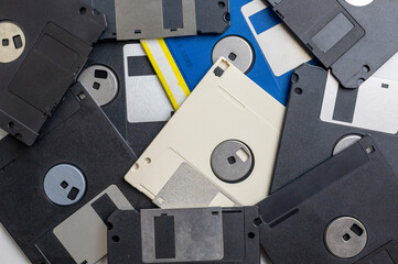Scattered old floppy disks close-up, top view. 1980s and 1990s computer technology.