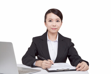Portrait of young businesswoman sitting at desk with folder