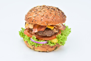 burger with melted cheese, ham, tomatoes and fried onions