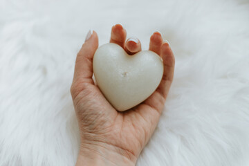 candle heart in hand. Valentine's Day