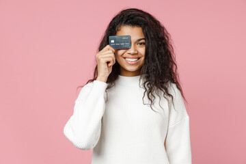 Young happy nice excited rich smiling african american curly woman 20s in white knitted sweater...