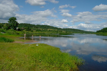 Fototapeta na wymiar calm northern river on a clear sunny summer day.