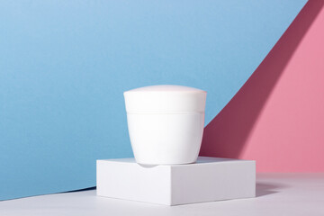 White tube of cosmetic products on a stand. Plastic container for cream, lotion, face mask. The concept of environmentally friendly, organic cosmetology.