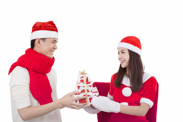 Portrait of young couple wearing Santa hats,holding gift