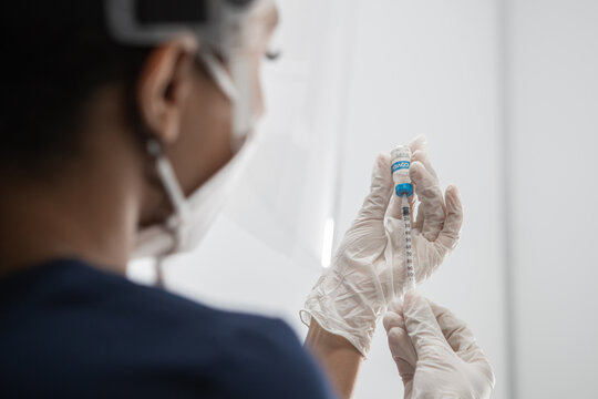 CU COVID-19 vaccine in doctor hands, African American Black female doctor holds syringe and bottle with vaccine for coronavirus cure. Concept of corona virus treatment, injection, vaccination