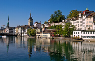 Limnat River Cityview in Zurich, Switzerland showing the  Church of St Peter spire in Summer