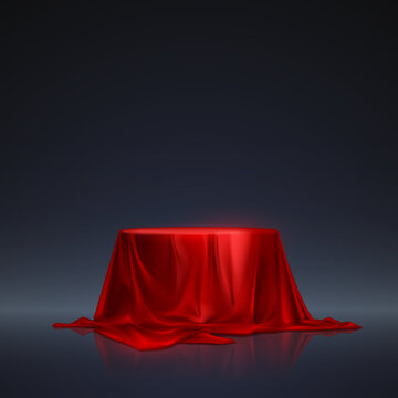 Red silk podium on dark background
