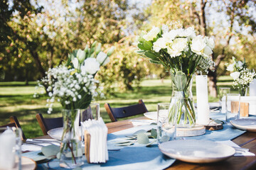 Festive table setting on a background of blue napkins. Tree branch.