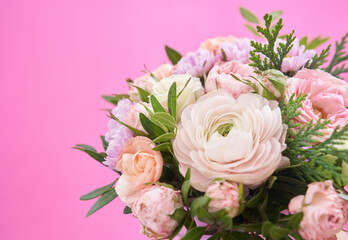 Bouquet of mixed flowers on pink background