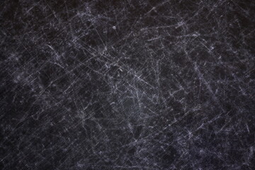 The texture of scratches on fabric on a black background, the texture of a silver reflector in the light