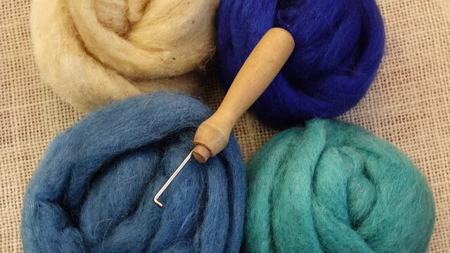 Wool of different colors for felting, felting needle, needlework