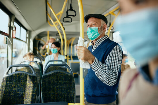 Senior man with protective face mask commuting by public transport. - Powered by Adobe