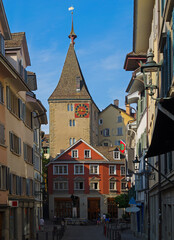Obraz premium Tower with a red clock on Neumarkt Street in the Rathaus quarter of Zurich, Switzerland