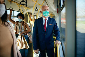 Senior businessman wearing protective face mask in a public transport.