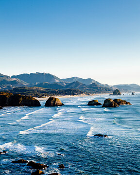 Rock formations jut out of the water along this piece of coast line in the pacific northwest.