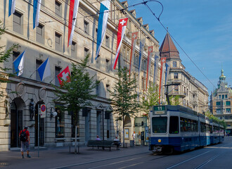 Fototapeta na wymiar A blue tram traveling along an iconic shopping street in Zurich, Switerland
