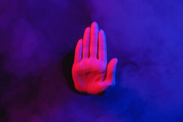 Woman is showing a stop gesture by her hand close up.