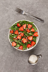 Strawberry salad with arugula and nuts. Healthy food. top view