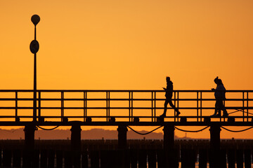 Spacer po molo o zachodzie słońca © Robert