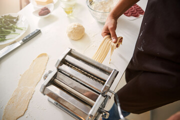 Unrecognized cook making pasta at home alone