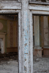 Fototapeta na wymiar Old window frame with broken glass and peeling paint