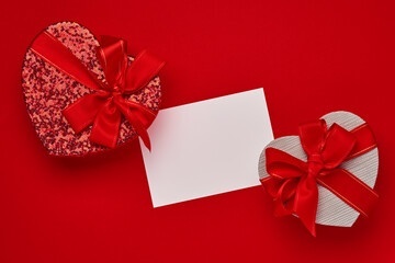 Various choices gift box in the form of heart with a red ribbon on a red background. Valentines day concept postcard. Top view flat lay with copy space.