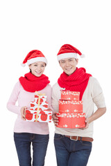 Portrait of young couple wearing Santa hats,holding gifts