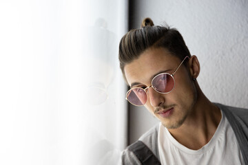 Portrait of a stylish young slavic hipster wearing sunglasses.
