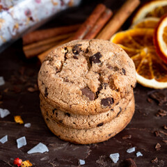 Organic food snack tasty sweet dessert milk dark chocolate chip salt cookie closeup piece fruit orange raspberry hazelnut nuts cinnamon on cocoa cacao powder wooden table for new year Christmas gift