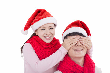 Portrait of young couple wearing Santa hats,smiling