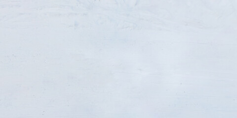panorama view from above on texture of snow covered road with car tire tracks and footprints