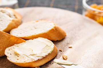 Bread and butter for homemade breakfast with coffee tea milk and organic slide whole wheat rye grain flour brown French  baguette with bio marmalade jam mix with orange passion fruit apricot