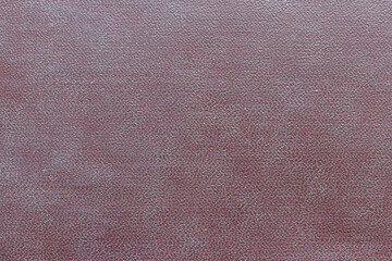 The surface of the brown old worn dermatin with a small pattern.