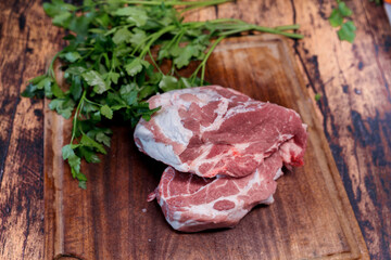 fresh pork loin on a cutting board for use on a wooden table