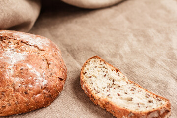 Crusty wholegrain bread on beige background. Copy space right. Stock photo