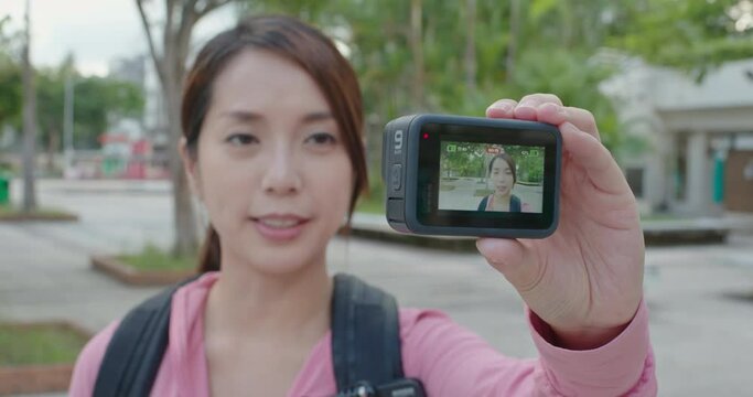 Hong kong 22 September 2020: Woman use action cam to take selfie vlog