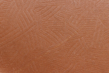 Fototapeta premium The surface of the brown old worn dermatin with a small pattern.