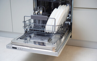 Open integrated dishwaher machine in a modern kitchen