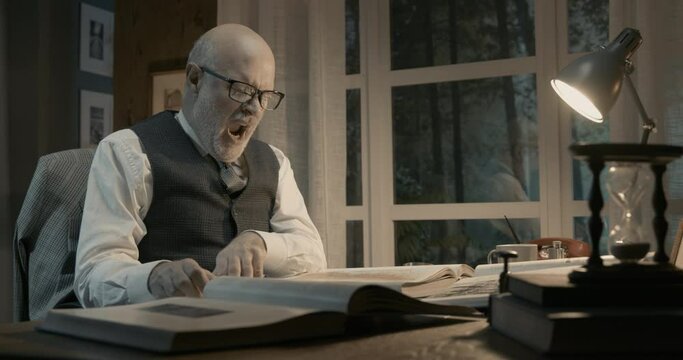 Academic professor studying all night in his office