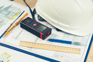 helmet and tools for construction drawings and construction drawings and laser rangefinder for...