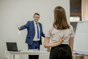 Angry boss yelling at his young employee, she is stressed and feeling frustrated: hostile boss and mobbing concept