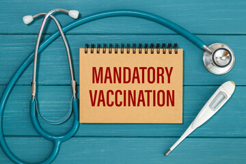 Notepad with the inscription Mandatory Vaccination and stethoscope