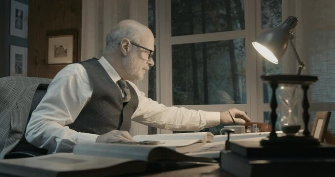 Professor sitting at desk and answering phone calls