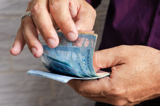 Hand Of Older Man Holding Brazilian Currency Money Banknotes. Economy, Salary, Credit, Payment, Shopping, Success Concept.