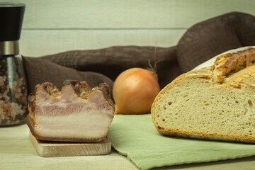 Pork tenderloin lard with meat on a wooden background with space for text
