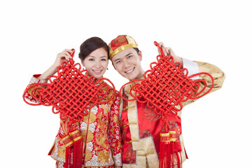 Portrait of young couple in Tang suits holding Chinese knots