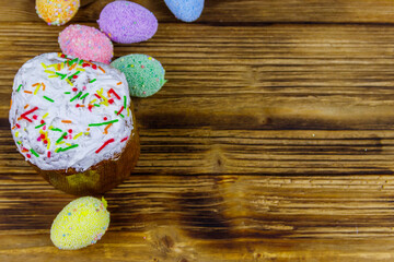 Easter cake and easter eggs on a wooden table. Top view, copy space